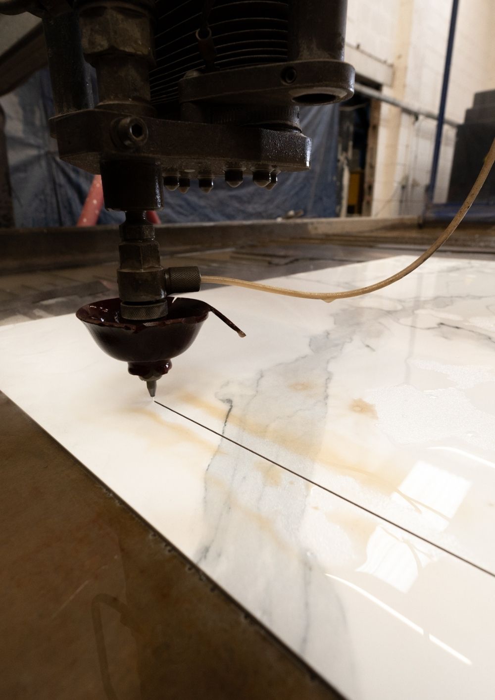 close up of a waterjet cutting through ceramic at Northwest Waterjet