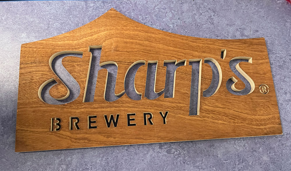 Wooden sign precision cut out by North West Waterjets