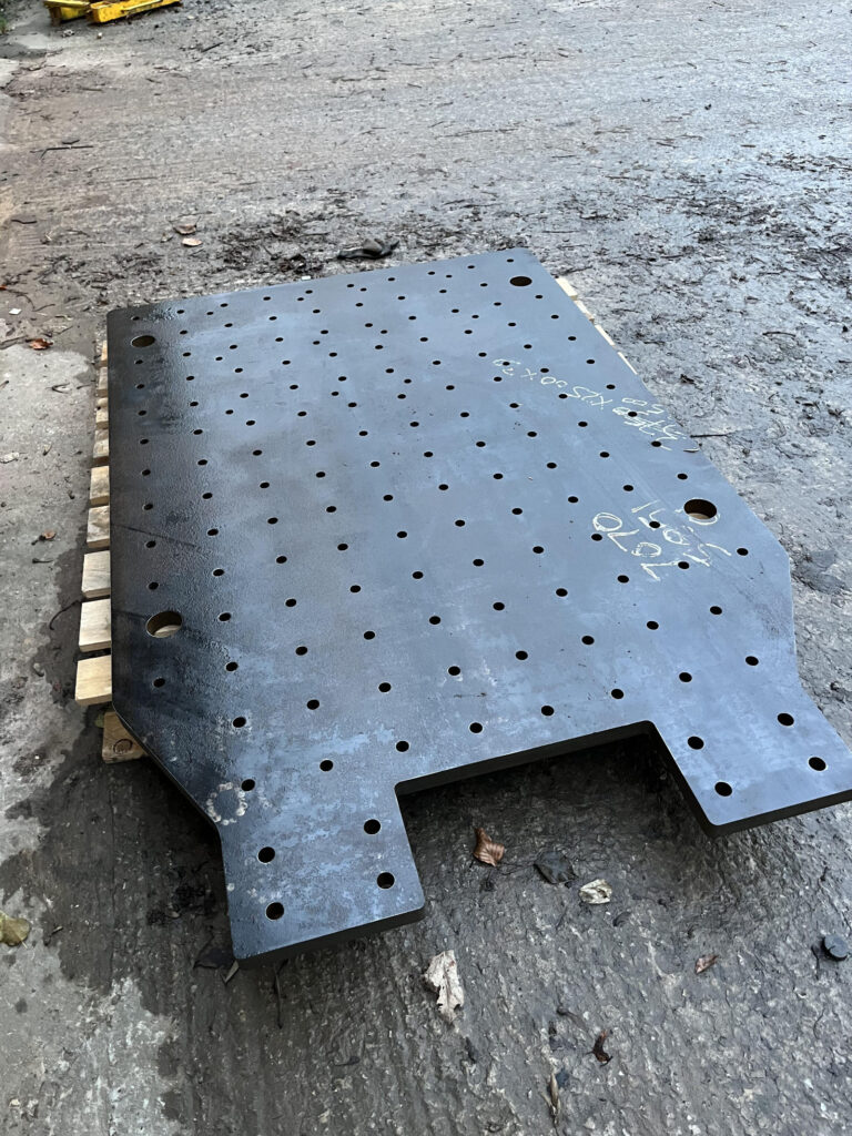 Heavy plate component with precision cut holes and profiles