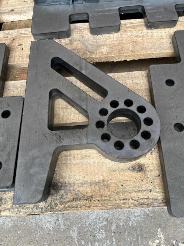 Precision cut metal component with detailed holes and internal profiles