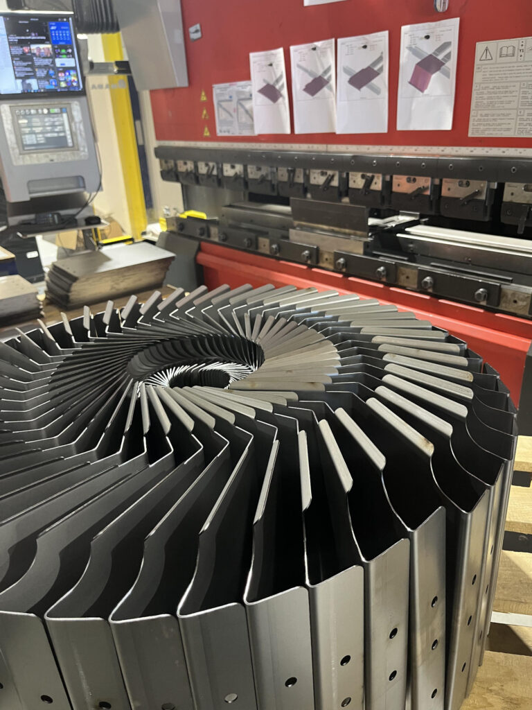 CNC folded metal components arranged in a circular batch