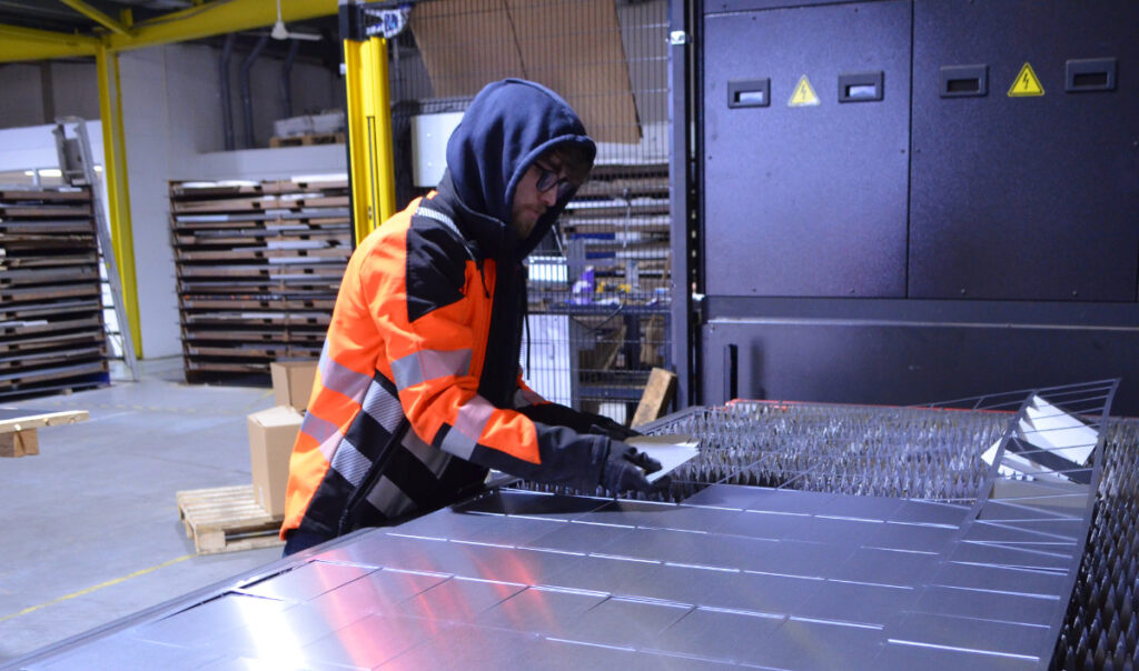 North West Waterjet operator removing cut metal from sheet